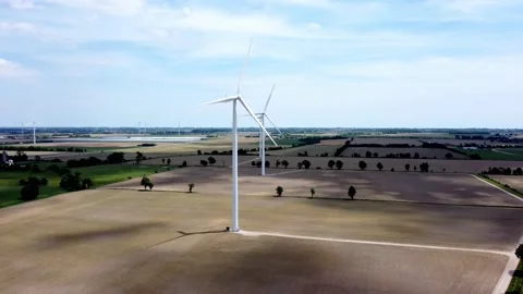 Renewable energy being generated by wind turbines on farmland creating Stock-Footage 159609655