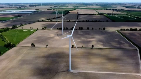 Renewable energy being generated by wind turbines on farmland creating 스톡 동영상 159609813