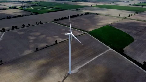 Renewable energy being generated by wind turbines on farmland creating 스톡 동영상 159609922