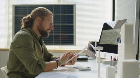 Renewable Energy Developer Using Digital Tablet during Workday Video stock 230104273