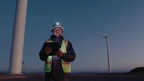 Renewable Energy Engineer Inspecting Wind Turbines with Tablet Stock Footage 237241206