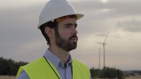 Renewable energy engineer talking on walkie talkie with hard hat and Stock Footage 247092135