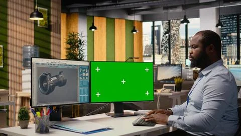 Renewable energy engineer works on wind turbine using green screen computer Fotos Stock