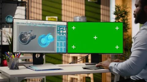Renewable energy engineer works on wind turbine using green screen computer Stock Photos