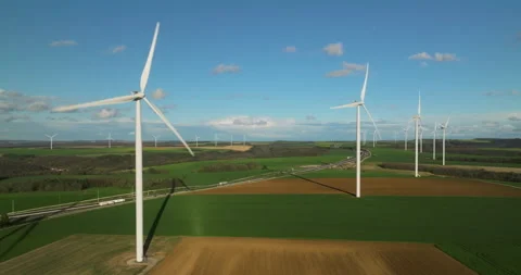 Renewable energy source. Aerial view of wind turbines standing on the green Stock Footage 239245869