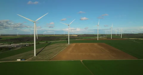Renewable energy source. Aerial view of wind turbines standing on the green Видео 239326253