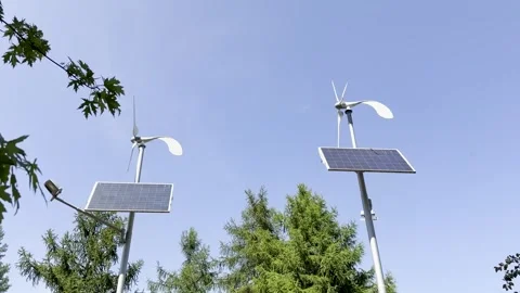 Renewable energy sources with solar panels and wind turbines in the city park Stock Footage 314460032