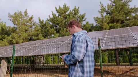 Renewable energy system designer connecting solar panels to electrical grids, en Stock Footage 300250155