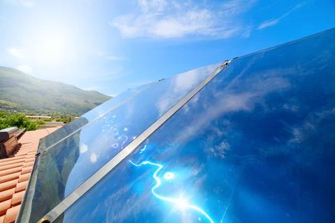 Renewable energy system with solar panel for hot water Stock Photos
