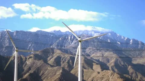 Renewable Energy - Wind Turbines Against Snow-Capped Mountains Stock Footage