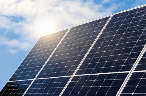 Renewable solar energy panel diagonal view on background of clean blue sky. Stock Photos