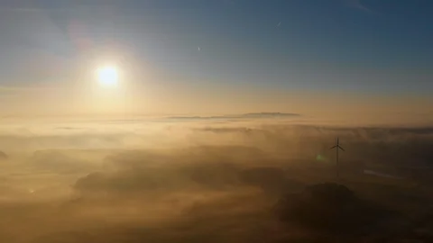 Renewable Sustainable Solar and Wind Energy During Foggy Sunrise Morning Light Stock Footage