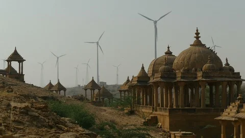 Renewable wind energy and ancient monument in deserts India Stock Footage