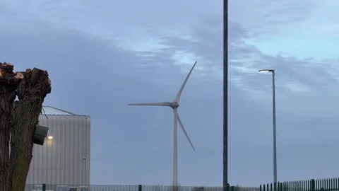 Renewable wind energy generator turning morning 4K Stock Footage 330948141