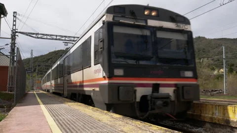 Renfe Operadora's Express regional train 247C entering the station Stock Footage 306959829