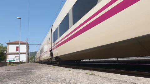 Renfe's Alvia train, passing through Barra de Mino train station Stock Footage 306475504