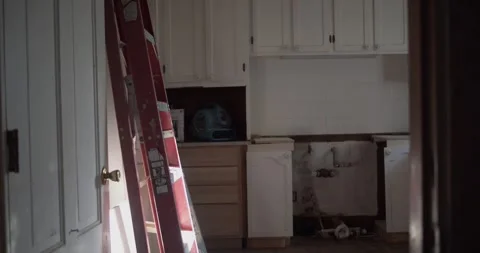 Renovated Kitchen Interior With Open Cabinets and a Red Ladder Stock Footage 343843753