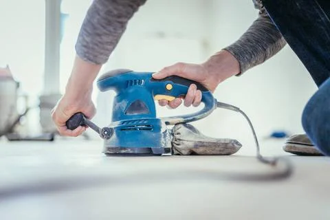 Renovating at home: sander tool for refreshing and grinding the wooden par... Stock Photos