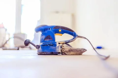 Renovating at home: sander tool for refreshing and grinding the wooden par... Stock Photos