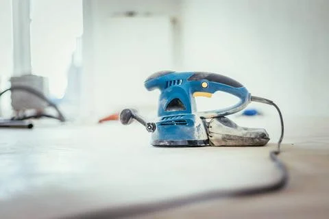Renovating at home: sander tool for refreshing and grinding the wooden par... Stock Photos
