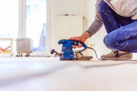 Renovating at home: sander tool for refreshing and grinding the wooden par... Stock Photos