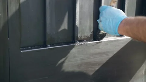 Renovation process of old eroded gate outside, workman polishing steel surface Stock Footage 220611353