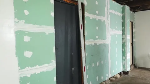 Renovation work with drywall installation in a home interior during daylight hou Stock Footage 326376015