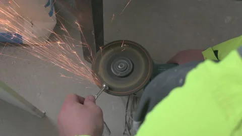Renovation work. Professional builder worker works with a grinder during repa Stock Footage 178365486