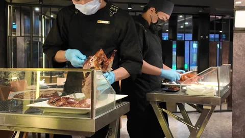 Renowned Duck Restaurant: Two Chefs Carving Peking Duck for Customers Stock Footage 294988946