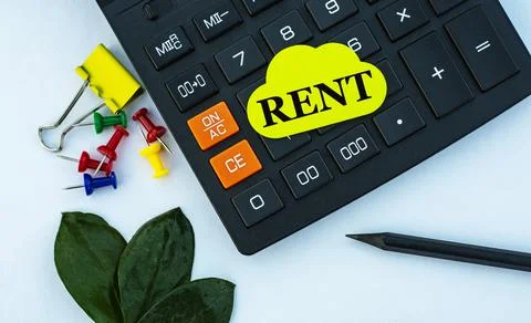 RENT - word on yellow note sheet on white background with calculator, pencil, Stock Photos