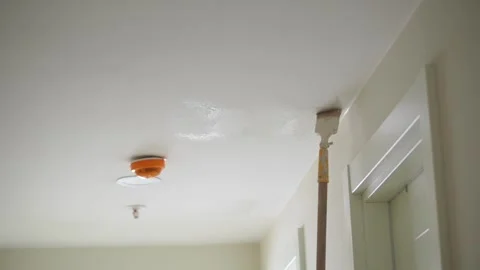 Repainting a ceiling in a bright room with simple tools Video stock 319054574