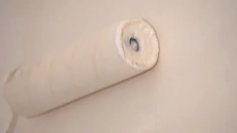 Repainting house -  passing the roller on the wall to whitewash it Stock Footage 130696651