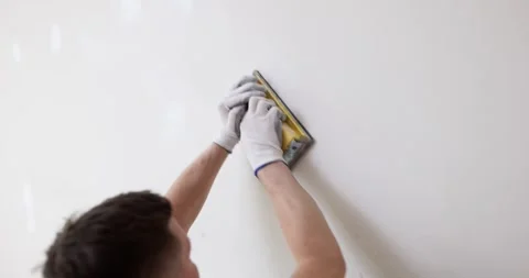 Repair of apartment and processing of wall with sandpaper Stock Footage 259179041