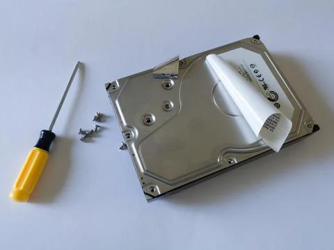 Repair broken computer part for data storage, unscrewed screw and screwdriver Stock Photos
