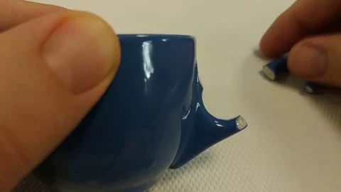 Repair a coffee cup with glue. Stock Footage 112006697