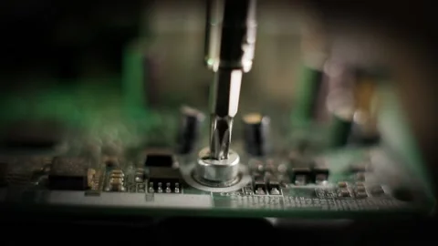 Repair computer and electronic devices. Screwdriver and screw Stock Footage 174896161
