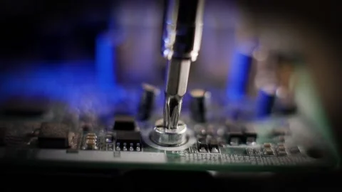 Repair computer and electronic devices. Screwdriver and screw Stock Footage 185372052
