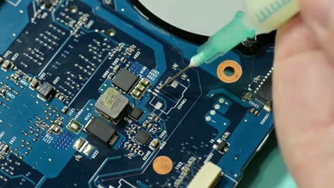 Repair computer circuit board: applying flux to the work space. Stock Footage 105341492