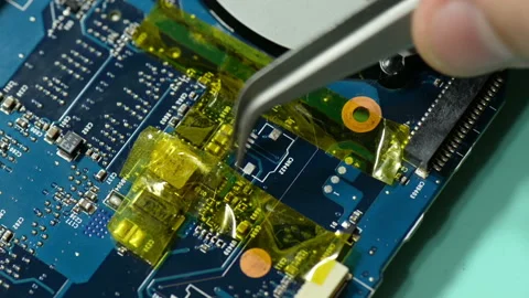 Repair computer circuit board: removing kapton tape. Stock Footage 105341351