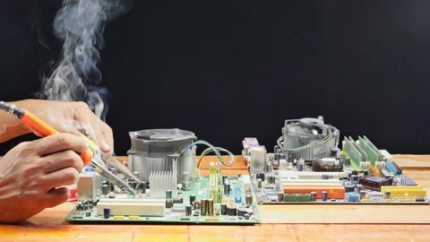.repair computer mainboard by using a soldering iron Stock Footage 172306894