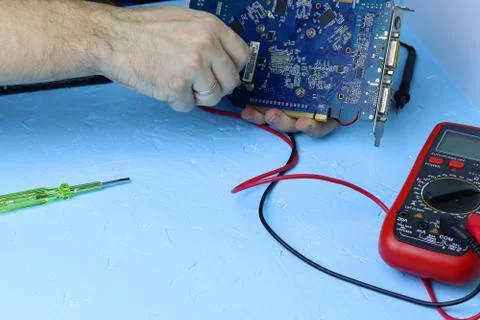 Repair an electronic device using Multimetr Stock Photos