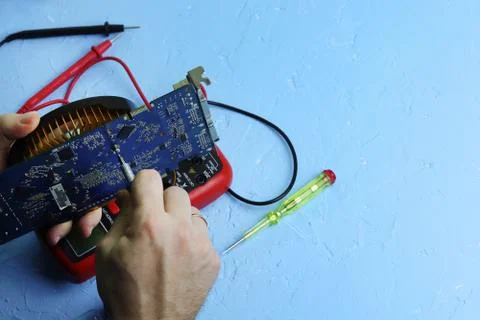 Repair an electronic device using Multimetr Stock Photos