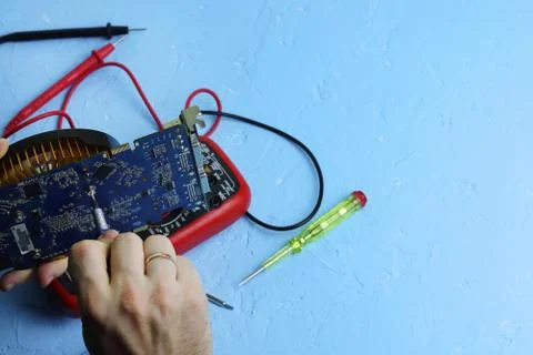 Repair an electronic device using Multimetr Stock Photos