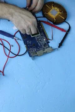 Repair an electronic device using Multimetr Stock Photos