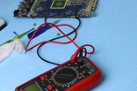 Repair an electronic device using Multimetr Stock Photos