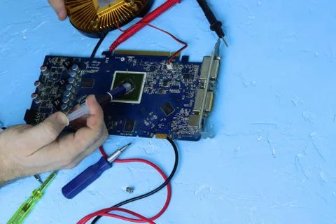 Repair an electronic device using Multimetr Stock Photos