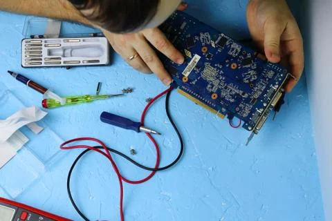 Repair an electronic device using Multimetr Stock Photos