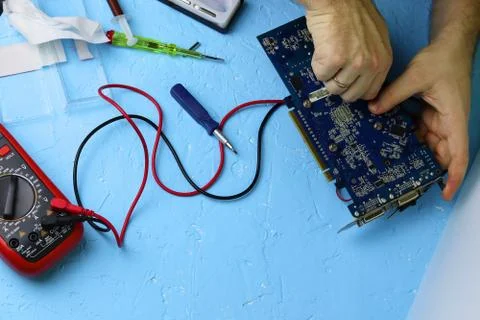 Repair an electronic device using Multimetr Stock Photos