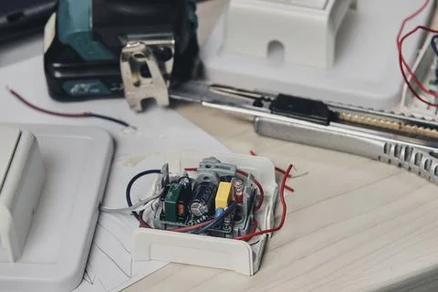 Repair of electronic devices, tin soldering parts. Hands of man holding screw Stock Photos