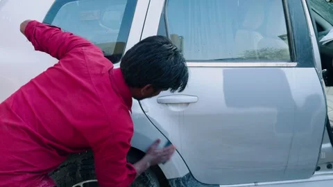 Repair expert sands down patch on car body outdoor Stock Footage 307277772